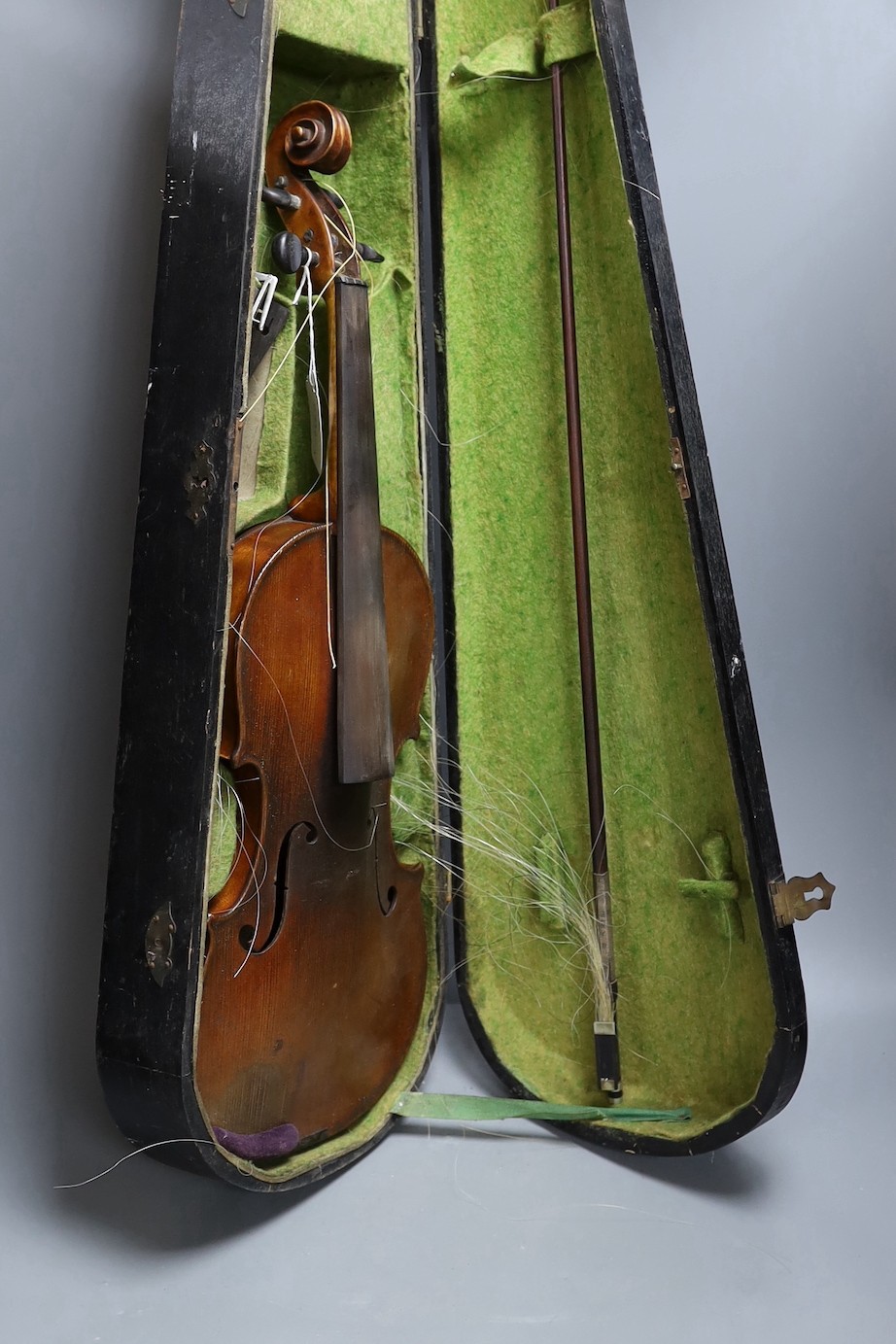 A cased 19th century violin, labelled Stradivarius 1690, with a Dodd bow